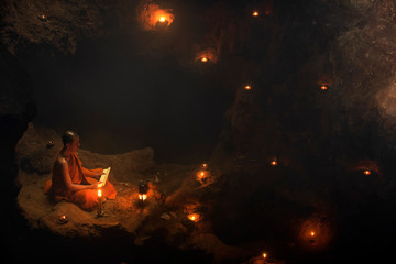 The meditation monk to follow the teachings of the Lord Buddha in the cave in Thailand. - obrazy, fototapety, plakaty
