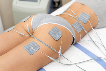 Beautiful woman getting electrostimulation therapy, anti-cellulite and anti-fat therapy on her...