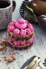 Retro telephone, fuchsia dessert, dark coffee on textured background.