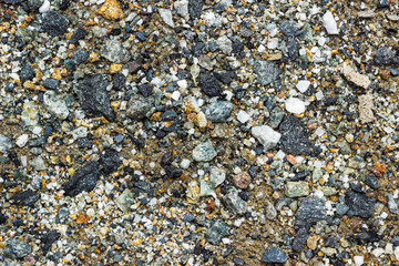 close up of multi colored small stones and sand, abstract background