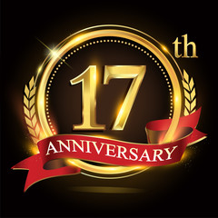 17th golden anniversary logo, with shiny ring and red ribbon, laurel wreath isolated on black background, vector design for birthday celebration.