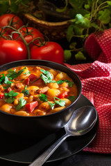 White bean soup with potatoes, tomatoes, paprika, and bacon