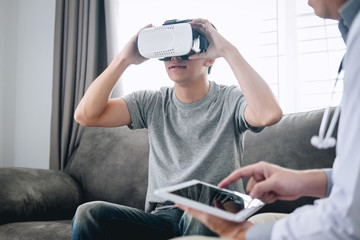 Young asian man patient using virtual reality glasses to see technology to examination physical body patient while doctor explains, 3D gadget technology, VR AR glasses