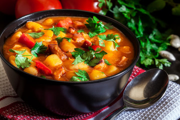 White bean soup with potatoes, tomatoes, paprika, and bacon