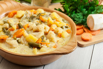 Vegetable soup with ingredients carrot, cauliflower, potato and parsley