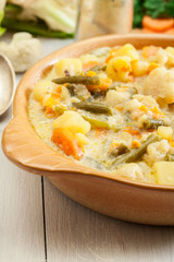 Vegetable soup with ingredients carrot, cauliflower, potato and parsley