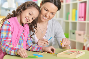 Fototapeta premium Close-up portrait of a charming little girl with mom