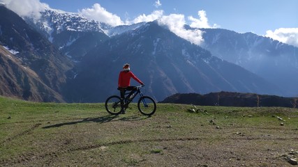 mountain biker in mountains, downhill.