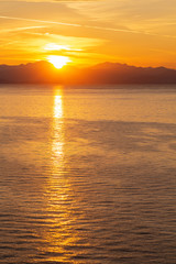 Summer sunrise on coast, Corfu island, Greece. Beach with perfect views of the mainland Greece mountains.