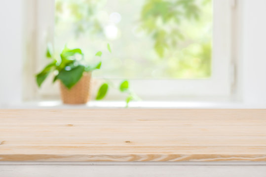 Plain wooden texture table on defocused summer window background