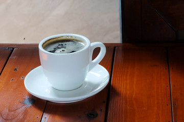 Well mixed hot black coffee in white coffee cup with space for write wording served in a restaurant in a coffee break time, popular drink for meeting place and party time, value added design for bette