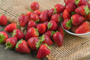 Stack of strawberries on sack cloth.