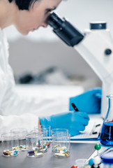 Fototapeta premium Medical Researcher Looking Through the Microscope