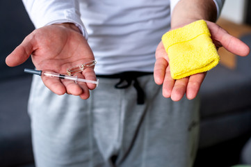 The man is holding medicine and a wristband. The concept of doping in sport.