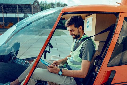 Concentrated short-haired man checking planed rout on his tablet