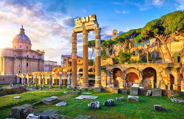 Roman Forum in Rome, Italy. Antique structures with columns and archs. Wrecks of ancient italian roman town. Church of Santi Luca e Martina. Sunrise above famous architectural landmark.