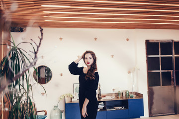 Fototapeta na wymiar beautiful young woman in costume posing in modern studio apartment 