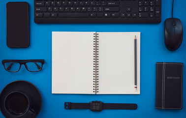 Blank white notepad with black office and personal accessories. - 260956589