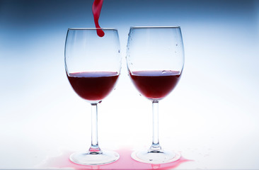 Splash red wine glass against a white background