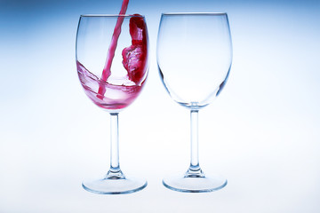 Splash red wine glass against a white background
