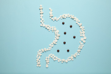 Stomach of pills, concept of food poisoning and toxins in body. Indigestion and abdominal pain.