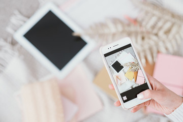 Social media user. Hobby and lifestyle. Like to profile. Woman taking smartphone photo. Freelance. Comfy home workplace.