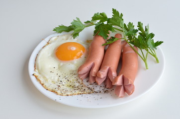 fried egg and bacon on a white plate