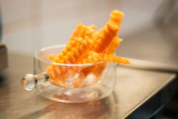 Girl chef slicing vegetables. Tomatoes, parsley, onion, apple. Wooden board for slicing vegetables.Curtain processes