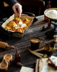 Homemade cinnamon pumpkin rolls in baking pan