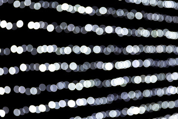 Abstract glitter sparkle bokeh defocused on black background. many round light on background