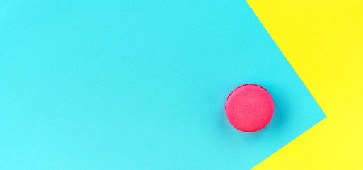 Pink macaroons on a yellow and blue background