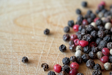 Peppercorns on wooden surface