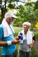 Mature couple drinks water to replenish energy and to hydrate