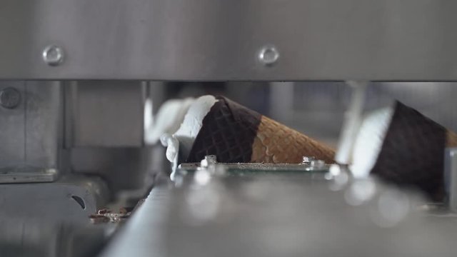 ice cream production, transportation waffle-cone with plombir ice cream on conveyor, production line, dairy products.