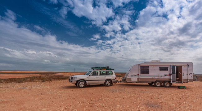 Four wheel drive vehicle and large caravan at roadside stop in the outback of Australia.