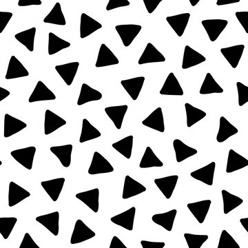 Hand drawn black and white vector doodle seamless pattern with scattered triangles, abstract geometric background in minimal style