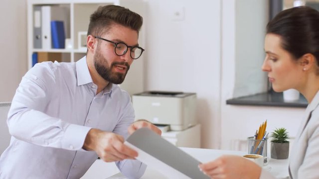 job, business and employment concept - female employer or hr manager having interview with male employee at office