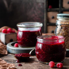 Two glass jars with homemade dark red jam