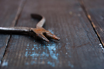 old pliers on black wooden