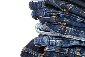 stack of various shades of blue jeans