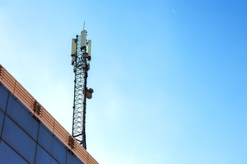 The cell tower with 3G, 4G and 5G communications. Base station for operating mobile phones, receiving and sending a signal. Antenna for wireless communication. Cellular systems in the city.