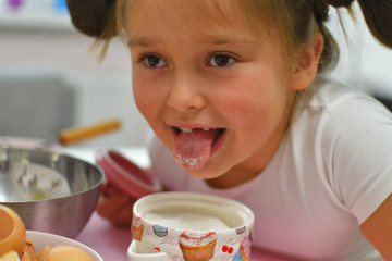 Little girl preparing cookies in kitchen at home. Cooking homemade food.Cooking is fun .Ingredients for baking Easter cake