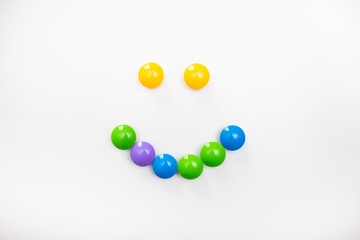 A smile made from children's toys. Multicolored figures for games