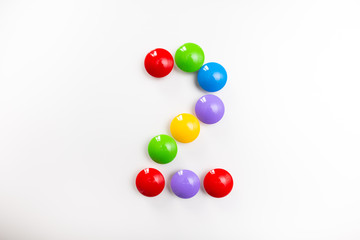 Digit 2 made from children's toys. Multicolored figures for games