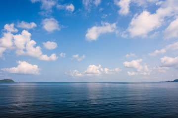 Naklejka na ściany i meble Sea on blue sky with cloud background