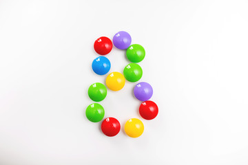Digit 8 made from children's toys. Multicolored figures for games