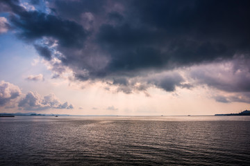 Fototapeta na wymiar Sea with the rain cloud background in morning