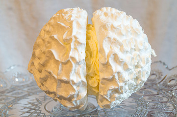 Meringue cake on a beautiful glass dish. Large, close-up. On a white background.