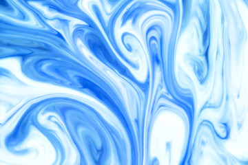 Blue and white paint pigment mix. Ornament mosaic swirl shapes background.