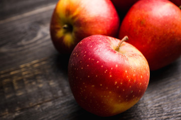 Close-up apples on the rustic wooden background. Selective focus. Shallow depth of field. 